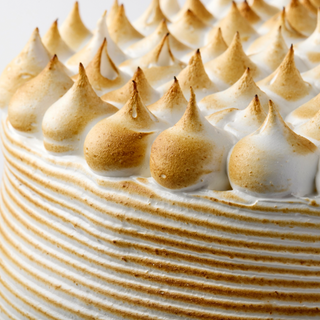 Layers of moist vanilla cake filled with dulce de leche and frosted in Italian Meringue